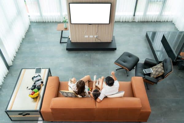 Top view of Asian happy family sitting and watching television in living room at home and spent quality time together, The Ultimate TV Setup For A Super Bowl Watch Party